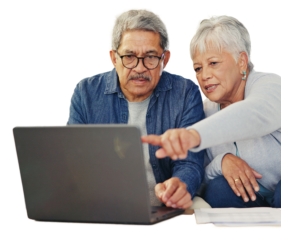 a lady pointing to a laptop screen while sitting next to her husband